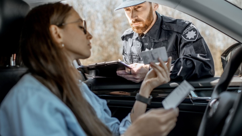 Officer administering a field sobriety test during a nighttime DUI traffic stop on the roadside